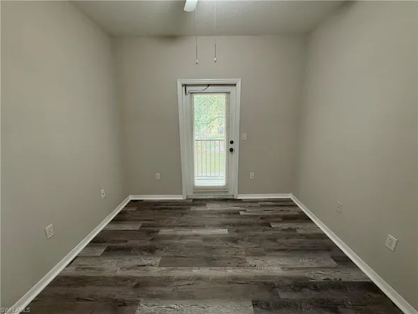 a view of a room with wooden floor and window