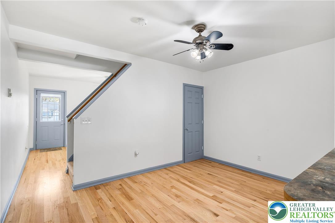 2507 Levans Road Coplay, PA 18037 - Photo 24 of 46 a view of a livingroom with wooden floor and a ceiling fan
