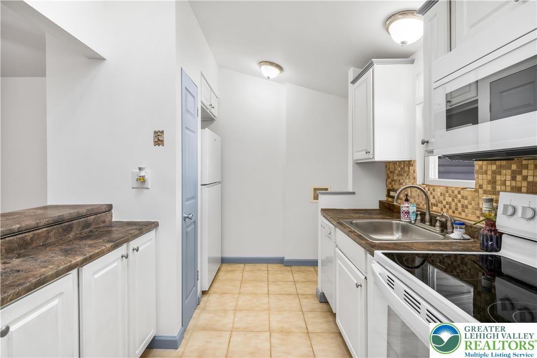 2507 Levans Road Coplay, PA 18037 - Photo 30 of 46 a kitchen with stainless steel appliances granite countertop a sink stove and refrigerator