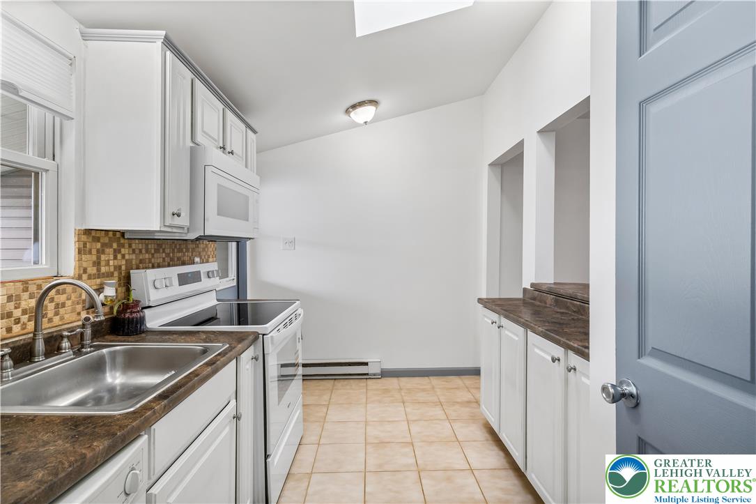 2507 Levans Road Coplay, PA 18037 - Photo 31 of 46 a kitchen with a sink a stove and cabinets