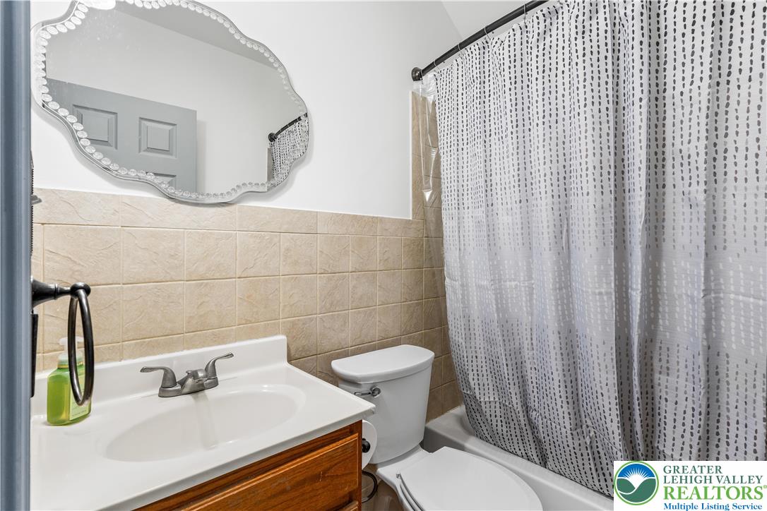 2507 Levans Road Coplay, PA 18037 - Photo 42 of 46 a bathroom with a sink a toilet and shower curtain