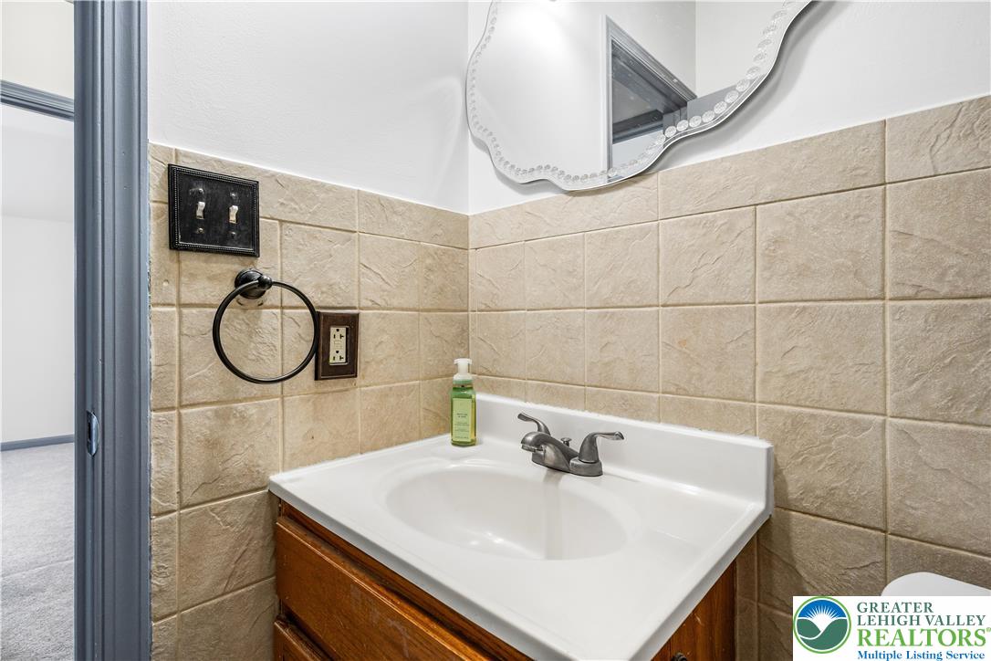 2507 Levans Road Coplay, PA 18037 - Photo 45 of 46 a bathroom with a sink a toilet and a mirror