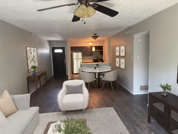 a living room with furniture and a wooden floor