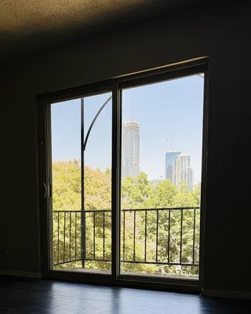 a room with painting on the wall and a window