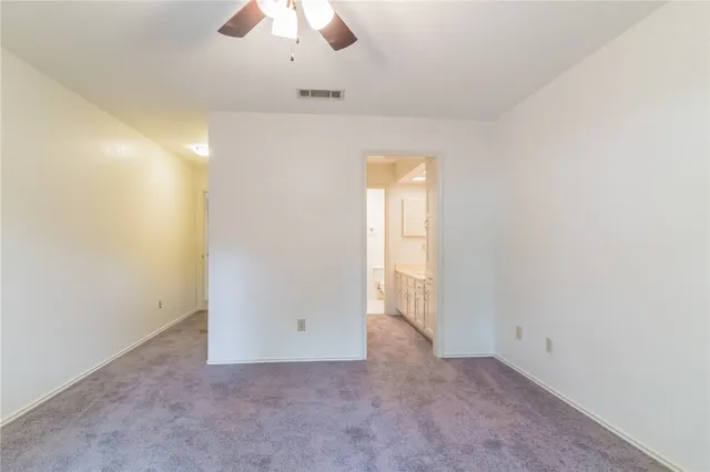 an empty room with a empty space and a ceiling fan