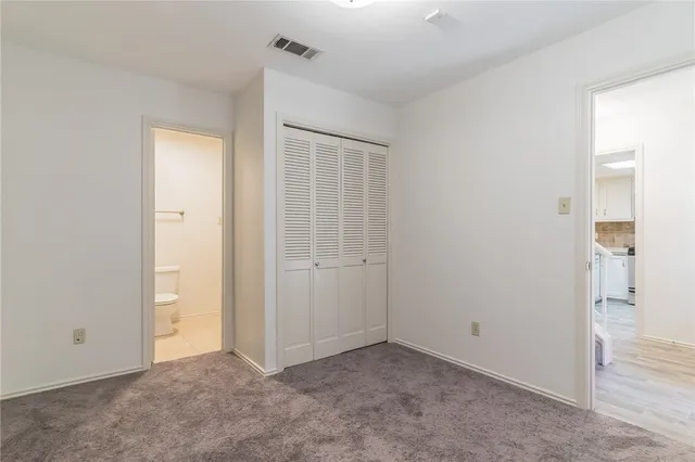 an empty room that has a mirror in it