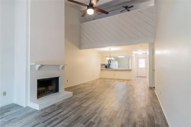 wooden floor in an empty room with a fireplace