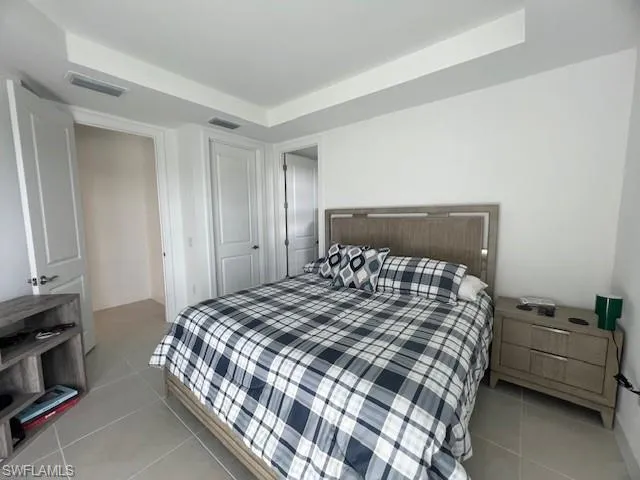 a bedroom with a bed and a night stand