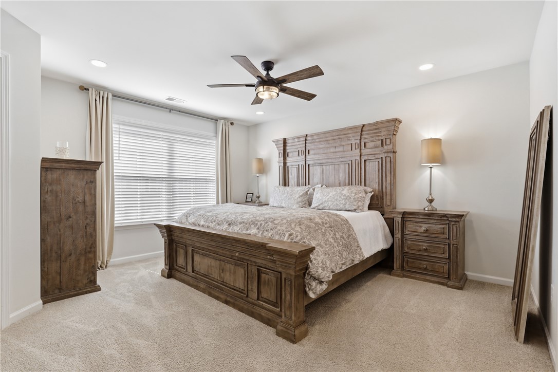 349 Stirrup Court Greer, SC 29651 - Photo 11 of 27 This tranquil primary bedroom features plush carpeting and abundant natural light.