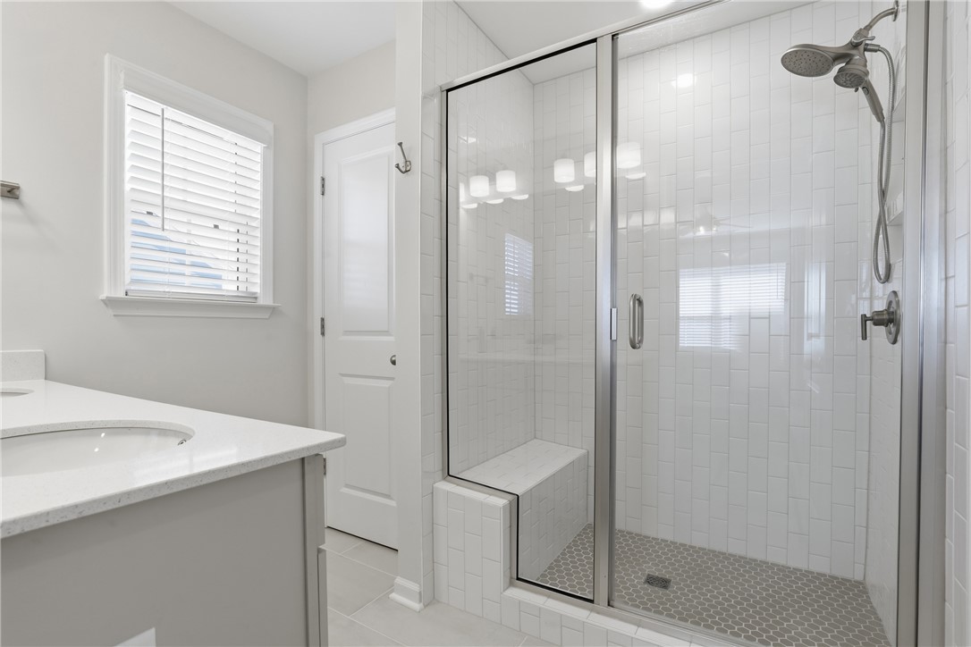 349 Stirrup Court Greer, SC 29651 - Photo 14 of 27 This serene bathroom offers a spacious walk-in shower and a modern vanity.