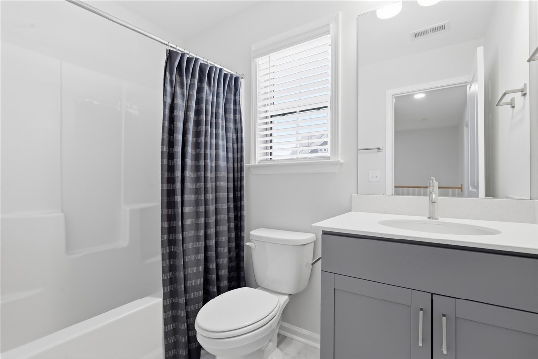 349 Stirrup Court Greer, SC 29651 - Photo 20 of 27 This bright bathroom features a modern vanity and a functional tub and shower combination.