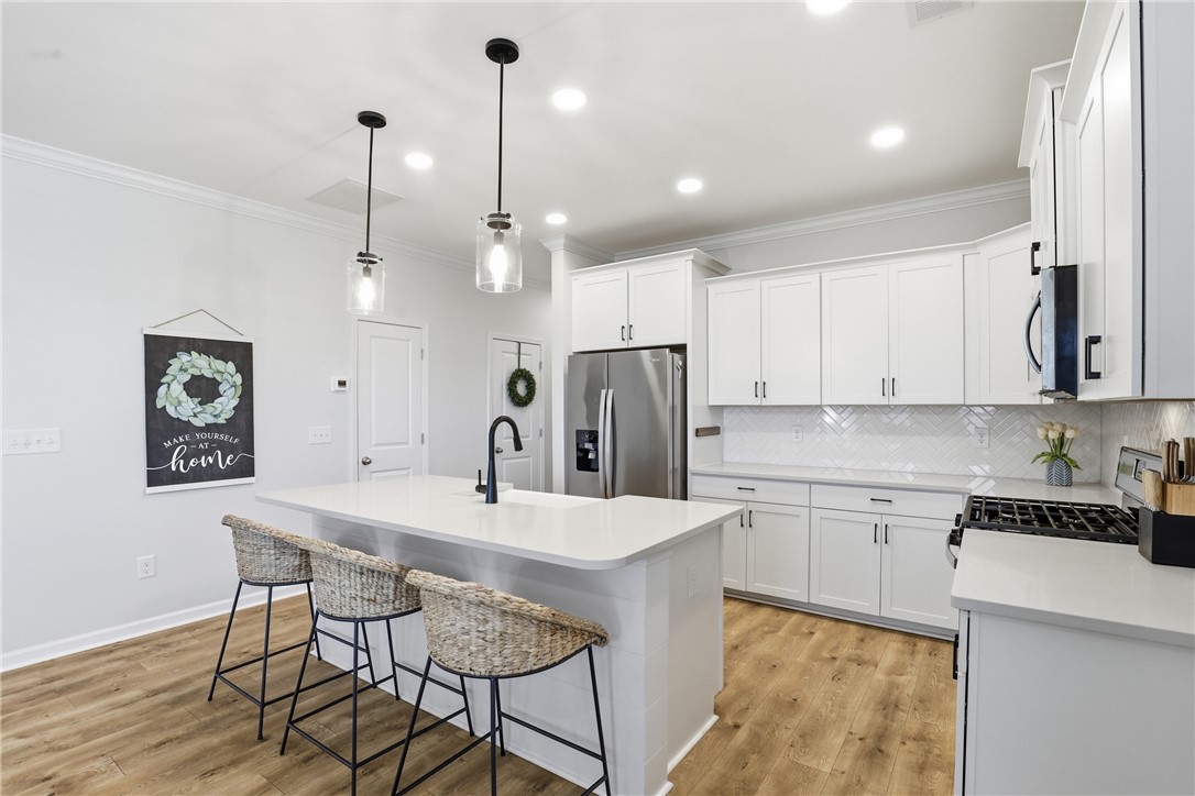 349 Stirrup Court Greer, SC 29651 - Photo 5 of 27 Bright and open kitchen with modern design elements and ample counter space.