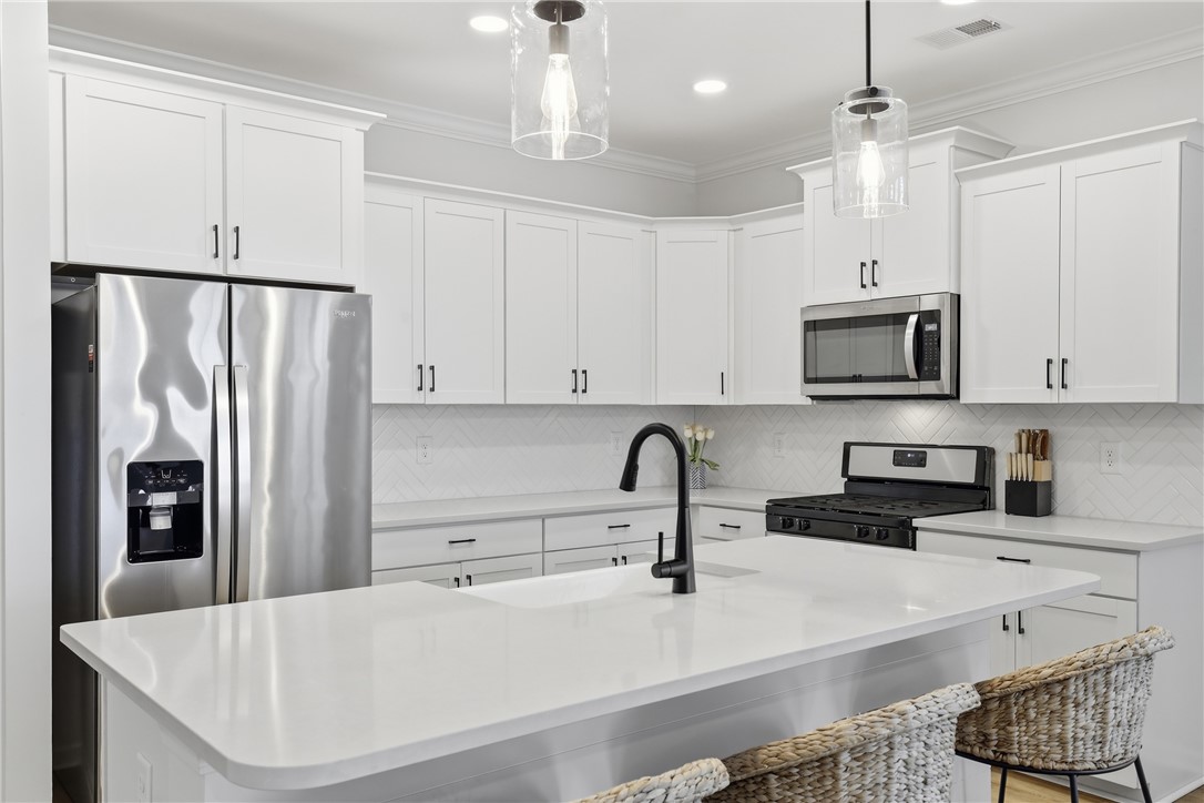 349 Stirrup Court Greer, SC 29651 - Photo 6 of 27 This bright kitchen features sleek appliances, ample counter space, and modern fixtures.
