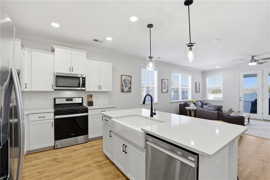 349 Stirrup Court Greer, SC 29651 - Photo 7 of 27 This bright kitchen with a large island flows seamlessly into the inviting living area.
