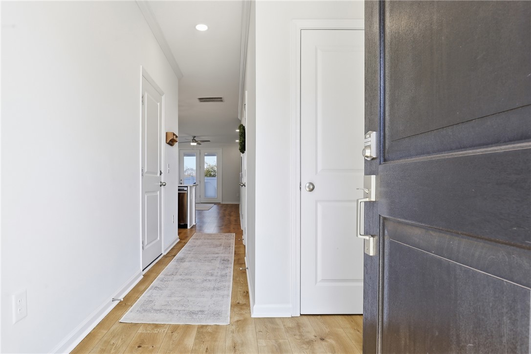 349 Stirrup Court Greer, SC 29651 - Photo 8 of 27 Enter into a bright hallway featuring wood floors and recessed lighting.
