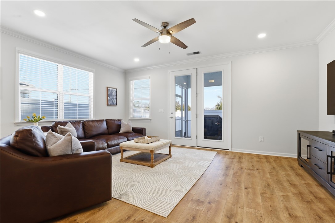 349 Stirrup Court Greer, SC 29651 - Photo 10 of 27 This bright living area features ample natural light, a ceiling fan, and access to an outdoor space.