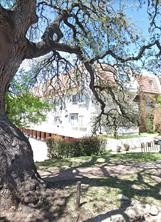 a view of a yard with wooden fence