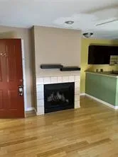 a living room with a fireplace and a flat screen tv