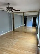 a view of a room with a ceiling fan