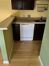 3115 Helms Street, Unit 313 Austin, TX 78705 - Photo 6 of 7 a kitchen with a sink and cabinets