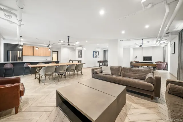 a living room with lots of furniture and kitchen view