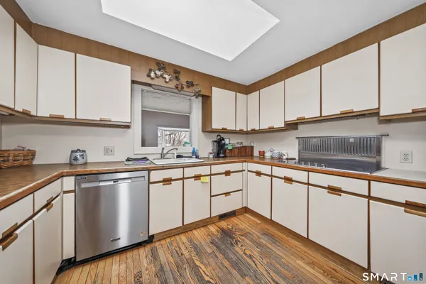 a kitchen with stainless steel appliances granite countertop a sink and cabinets