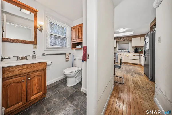 a bathroom with a sink a toilet and a mirror