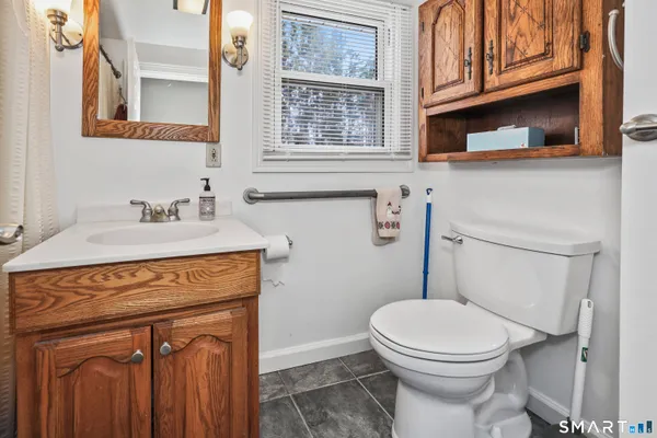 a bathroom with a sink a toilet and a mirror