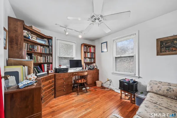 a work room with furniture and a bookshelf