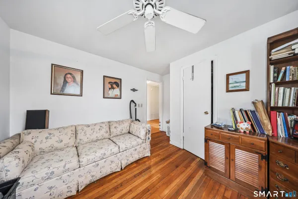 a living room with furniture and a book shelf