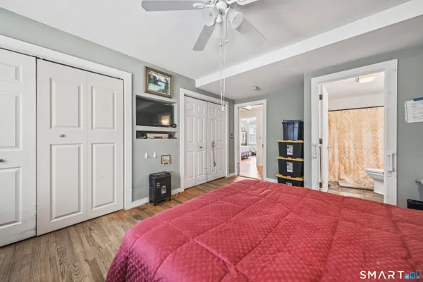 a spacious bedroom with a bed and a television