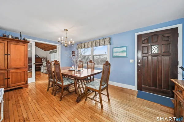 a view of a dining room with furniture and wooden floor