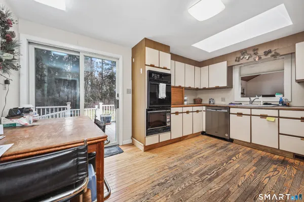 a kitchen with granite countertop a stove a sink and a refrigerator