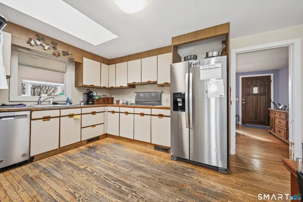 a kitchen with stainless steel appliances granite countertop a refrigerator sink and cabinets