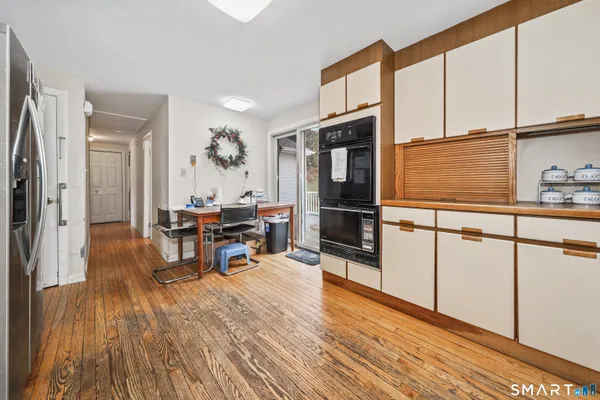 a living room with furniture wooden floor and a table