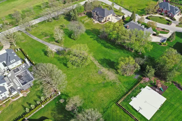 an aerial view of residential houses with outdoor space and street view