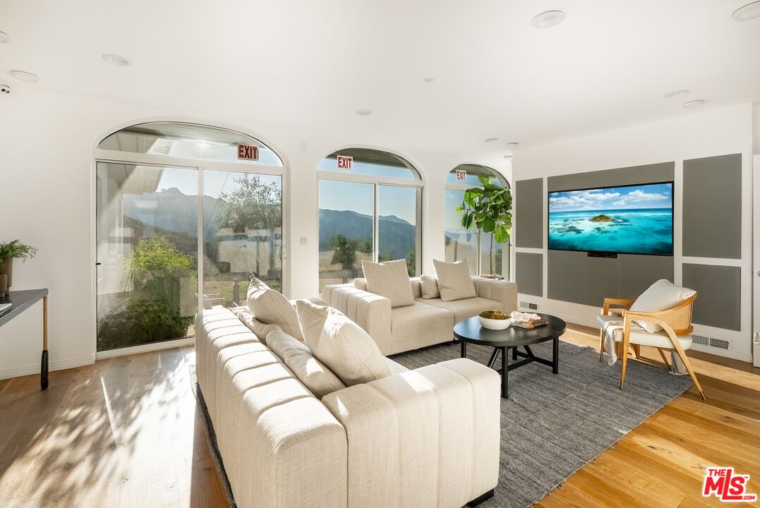 21965 Saddle Peak Road Topanga, CA 90290 - Photo 13 of 56 a living room with furniture and a large window