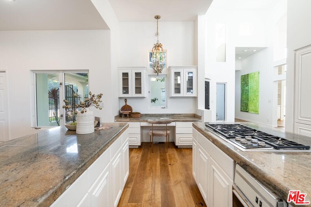 21965 Saddle Peak Road Topanga, CA 90290 - Photo 14 of 56 a kitchen with stainless steel appliances granite countertop a sink stove and refrigerator