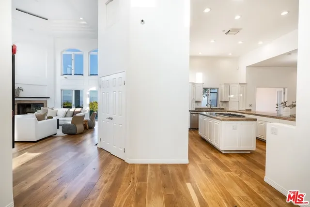a kitchen with granite countertop a sink and white cabinets