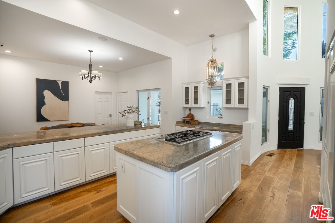 21965 Saddle Peak Road Topanga, CA 90290 - Photo 18 of 56 a kitchen with granite countertop a sink and white cabinets