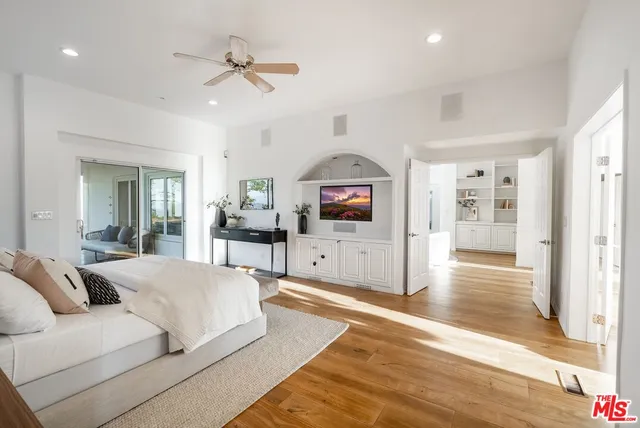 a bathroom with a tub a sink a mirror and a shower
