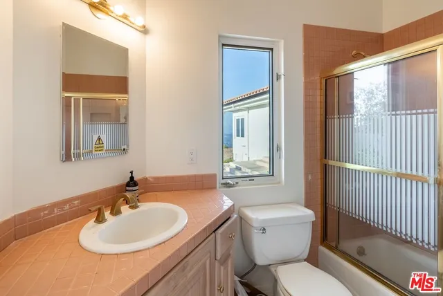 a bathroom with double vanity sinks and a mirror