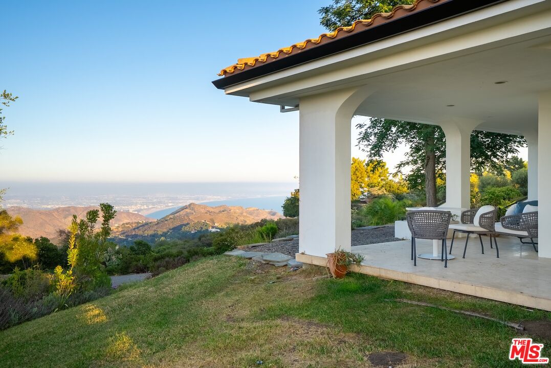 21965 Saddle Peak Road Topanga, CA 90290 - Photo 37 of 56 a view of a patio with chairs and table
