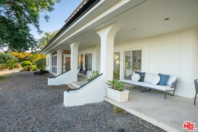 a view of a swimming pool with an outdoor space and seating area