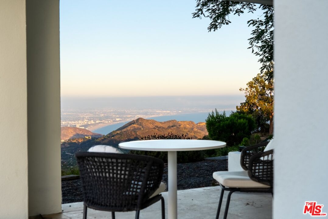 21965 Saddle Peak Road Topanga, CA 90290 - Photo 41 of 56 a view of a balcony with furniture and a potted plant