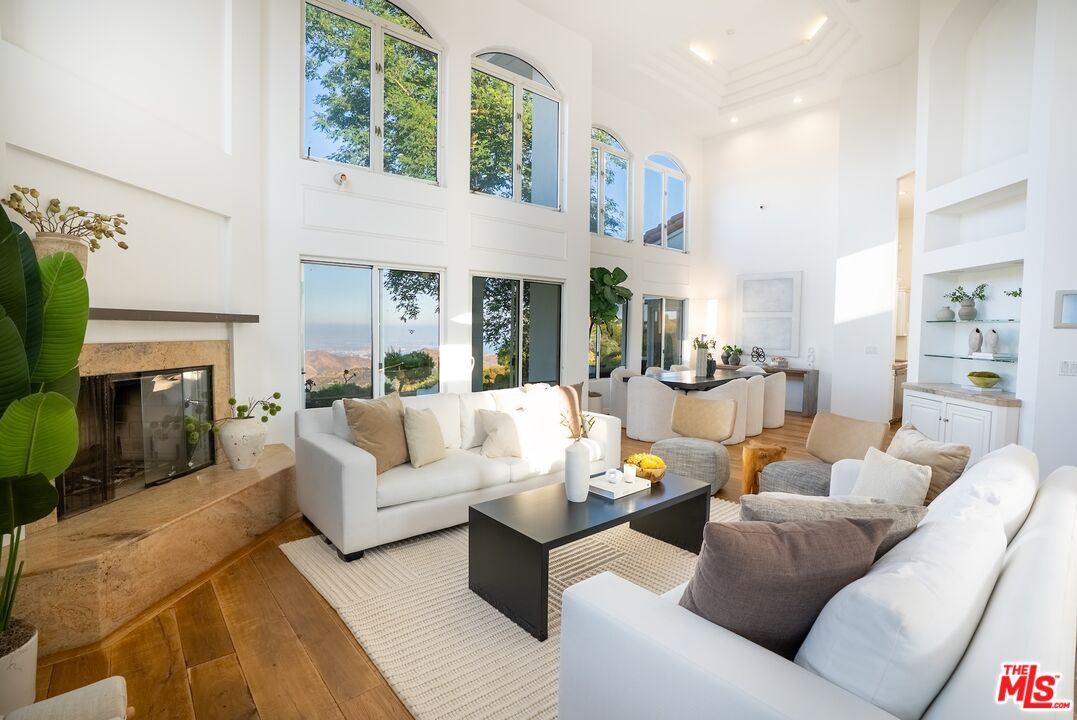21965 Saddle Peak Road Topanga, CA 90290 - Photo 7 of 56 a living room with furniture and a fireplace
