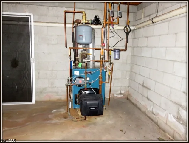 a view of a yard with plants and large trees