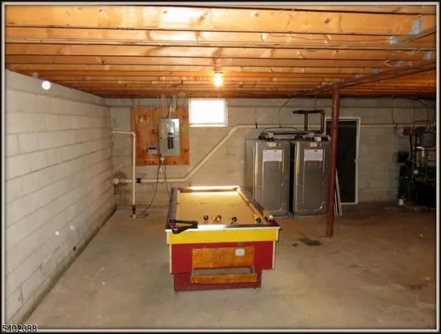 a room with water heater and a wooden cabinets