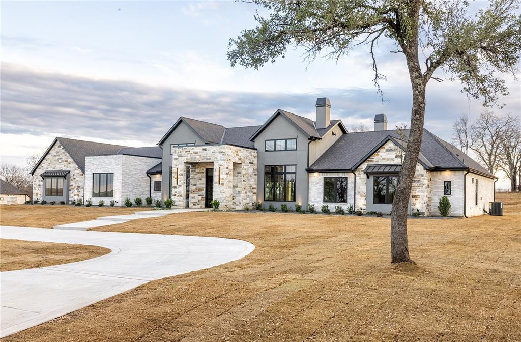204 Dan Russell Weatherford, TX 76087 - Photo 3 of 40 a front view of a house with a yard and garage