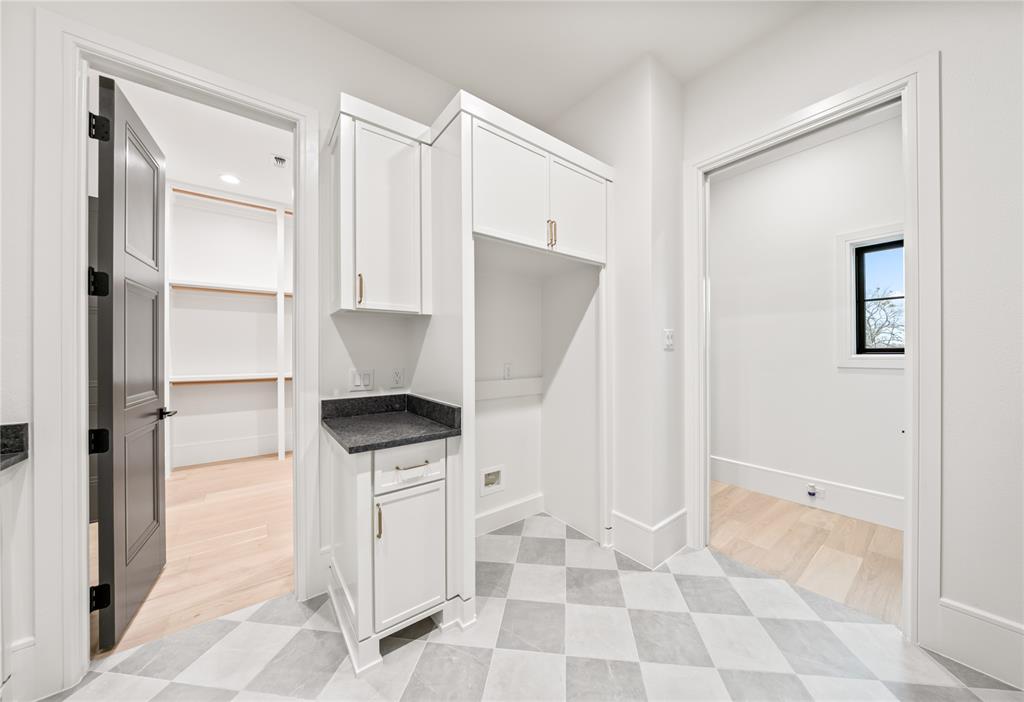 204 Dan Russell Weatherford, TX 76087 - Photo 35 of 40 a kitchen with white cabinets and white appliances